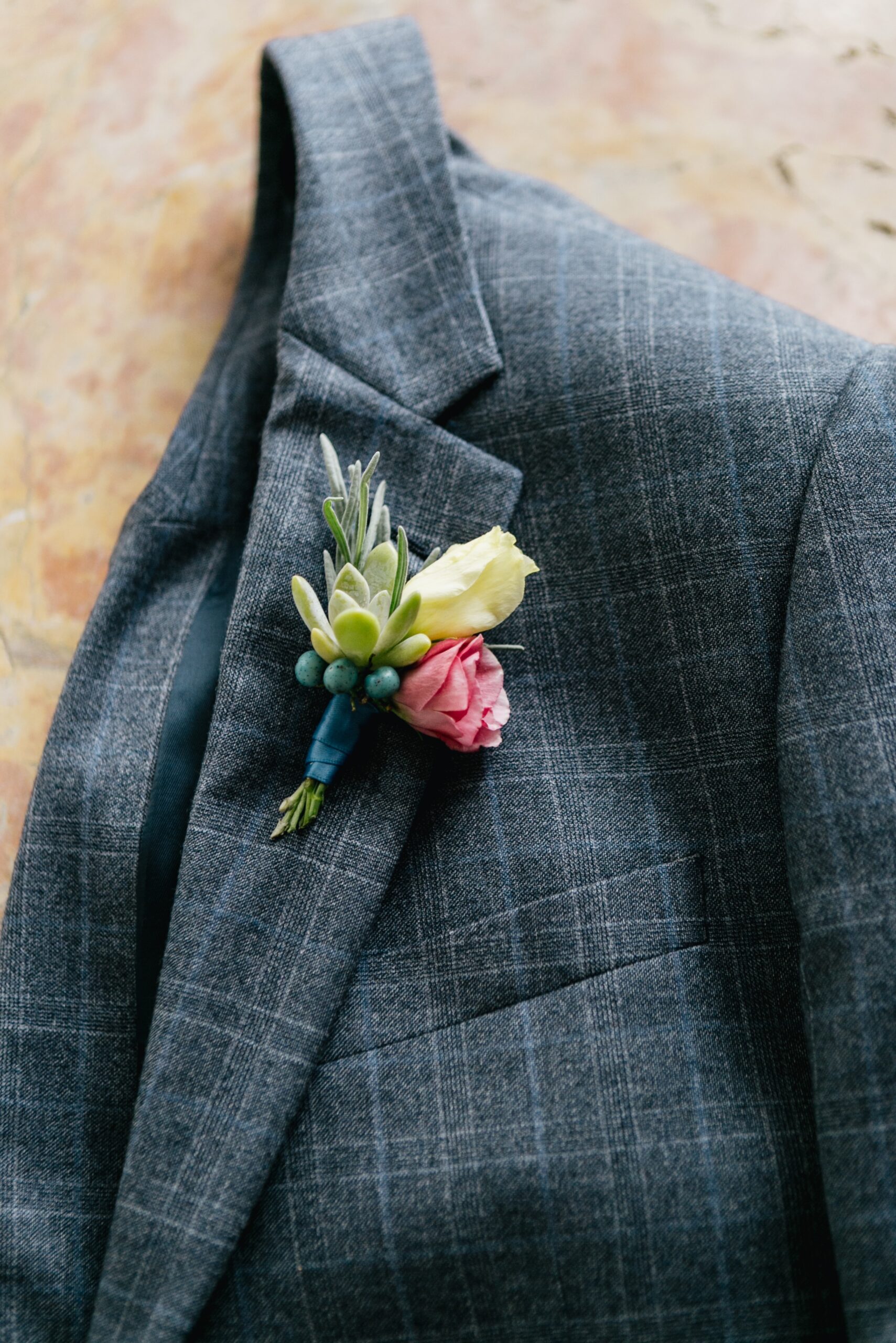 Groom's eclectic boutonniere with succulents on a bright wedding day in Philadelphia