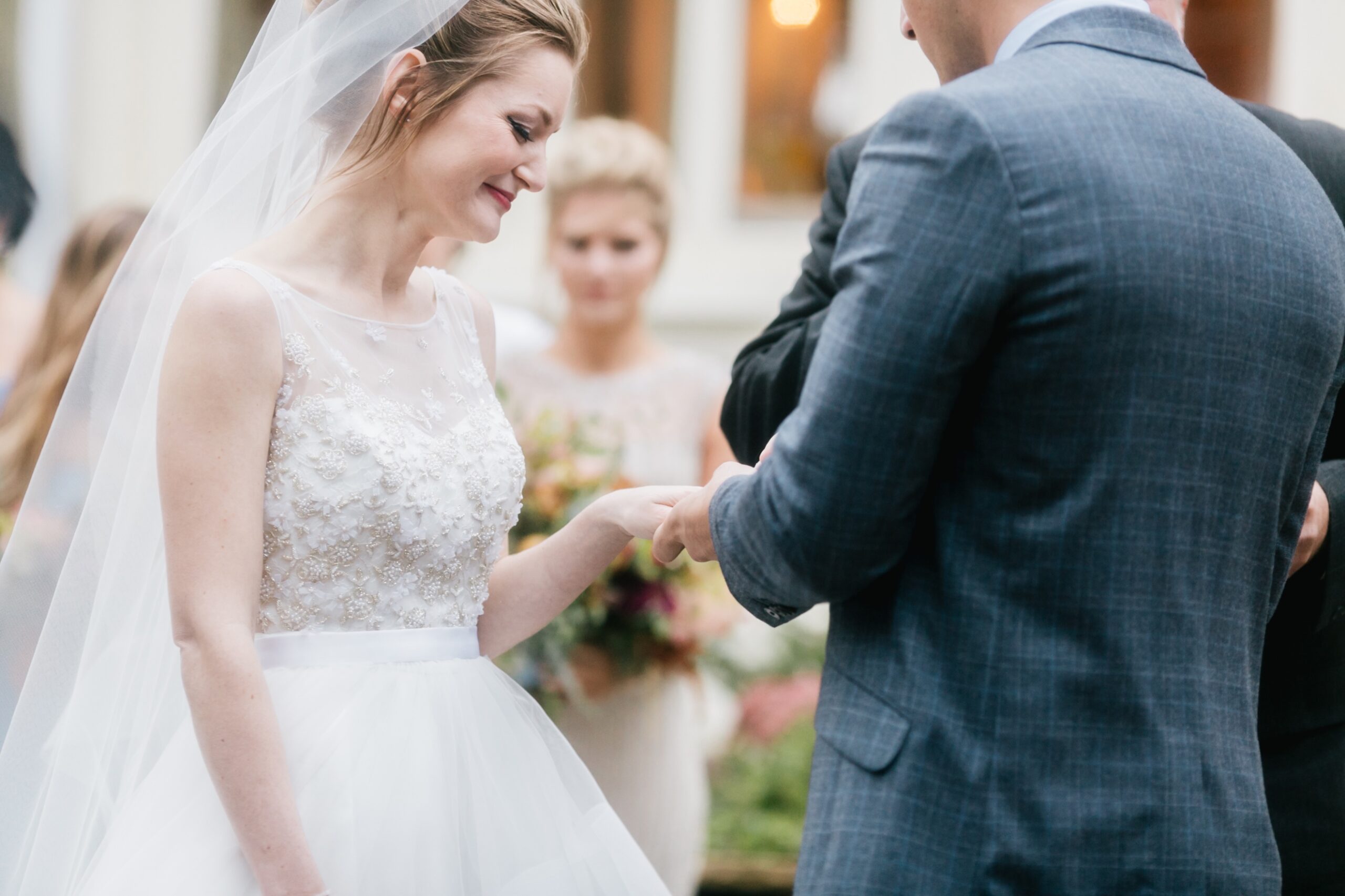 Bride and groom exchanging rings on an eclectic summer wedding day by Emily Wren Photography