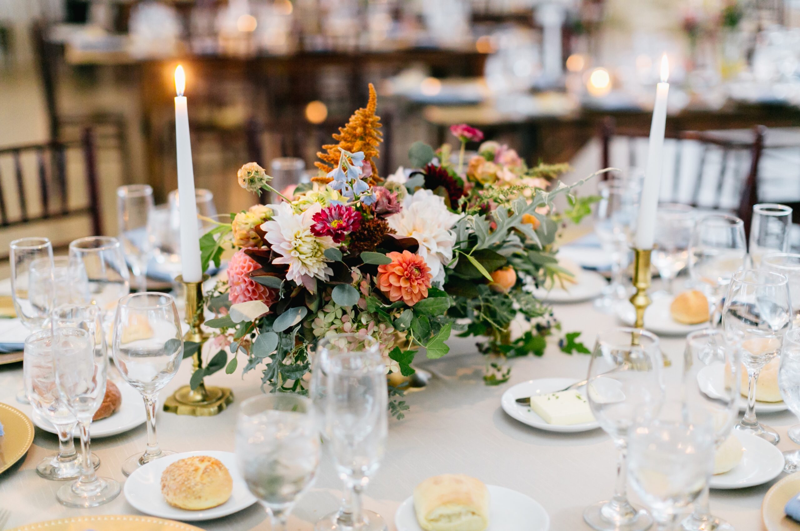 Low table centerpiece with bright flowers and candles