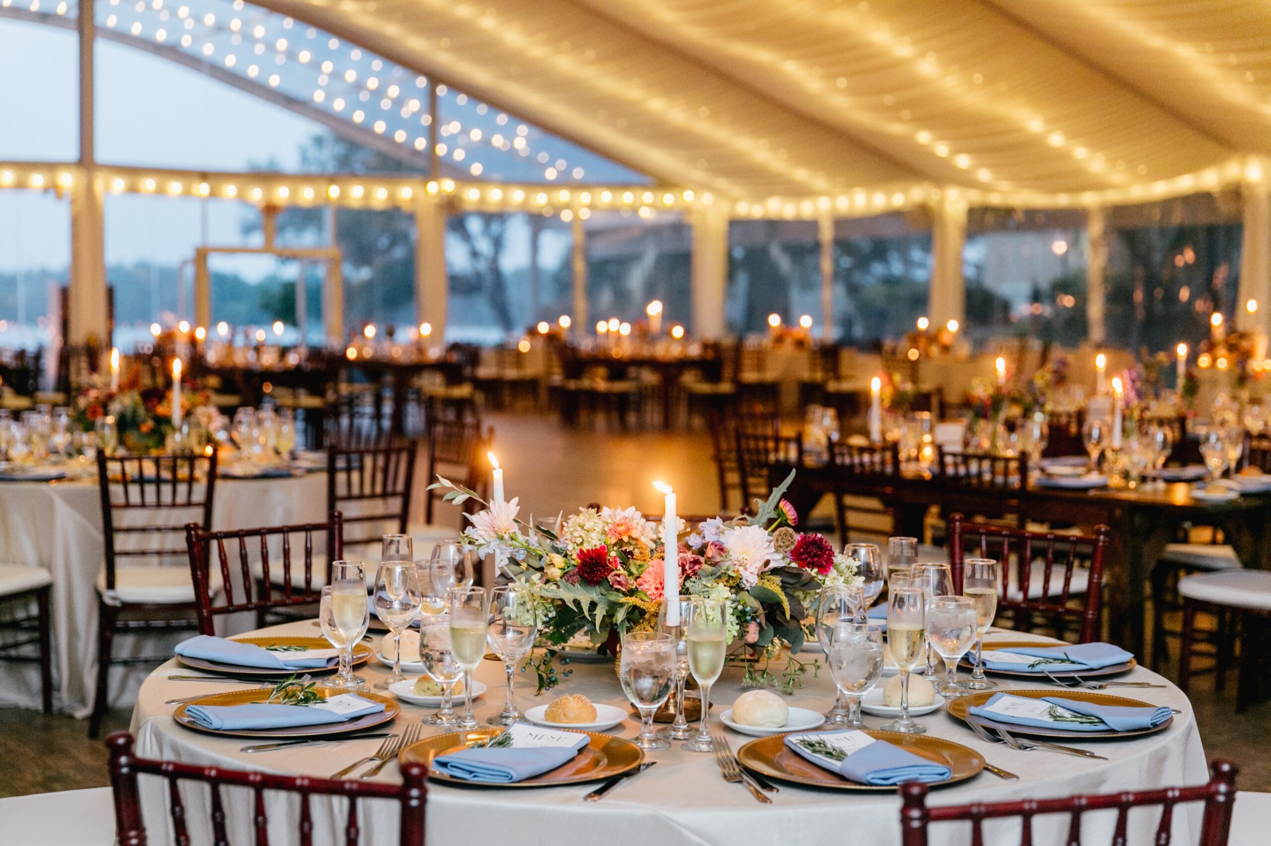 Tented reception with twinkle lights and colorful eclectic table decor