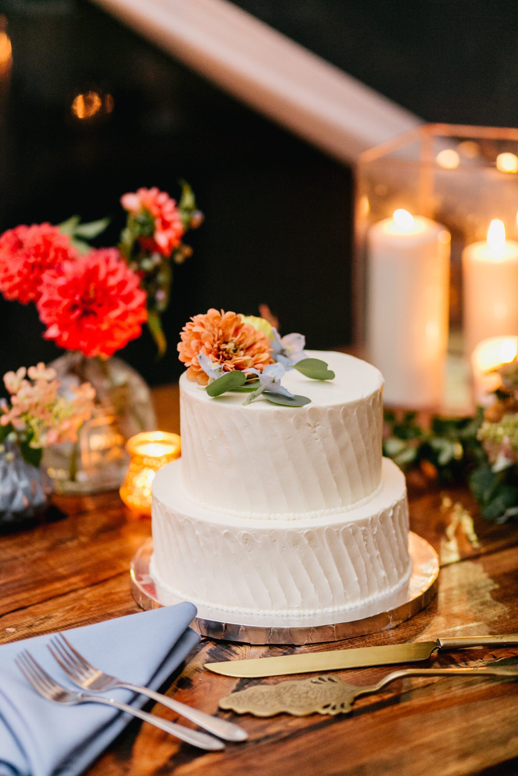 Simple wedding cake with bright flowers on top