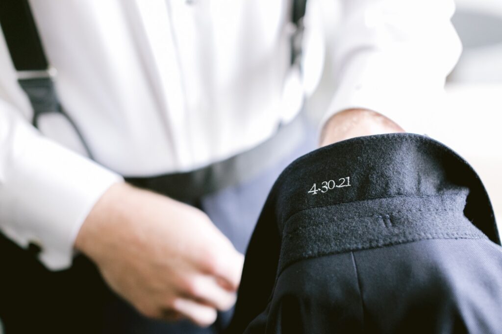 Wedding date embroidered on a groom's suit jacket