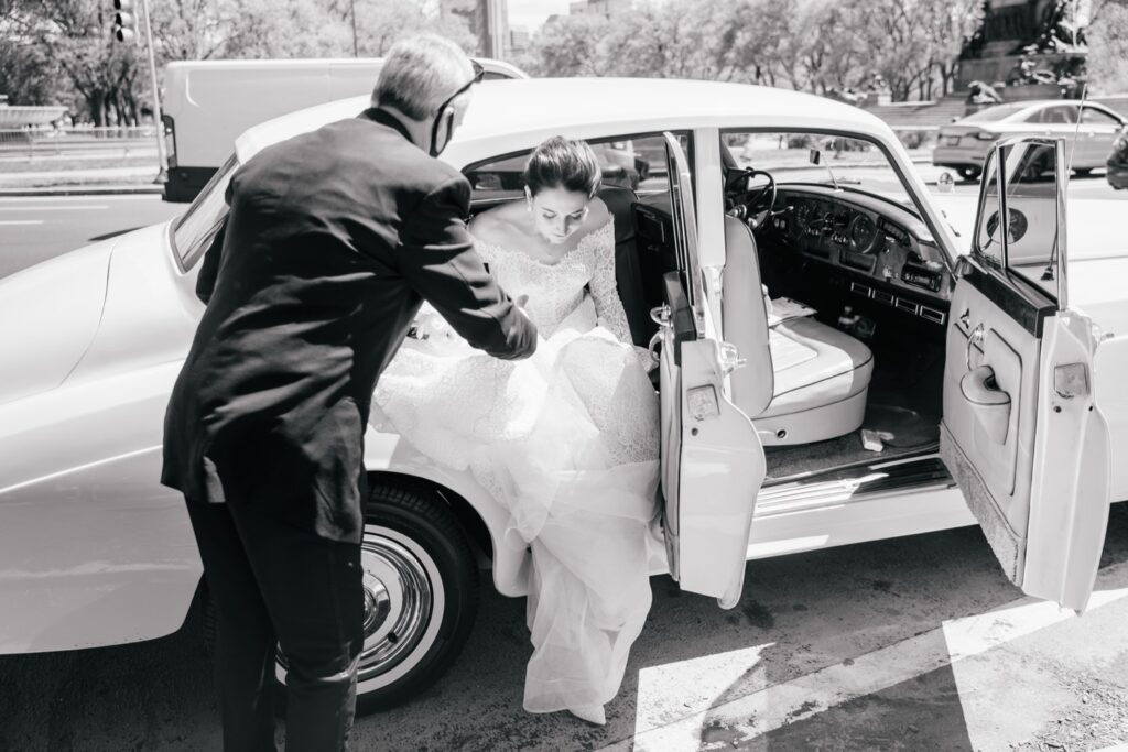 Bride getting out of a classic car before an elegant wedding at Water Works