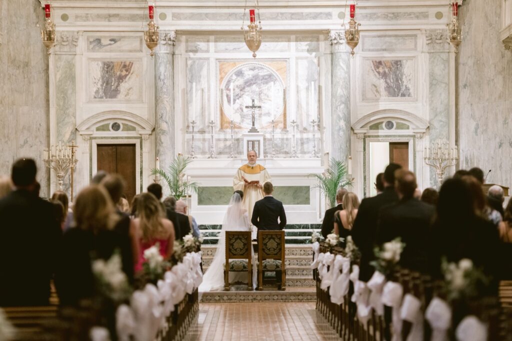 Bride and groom at the altar at a church wedding ceremony by Emily Wren Photography