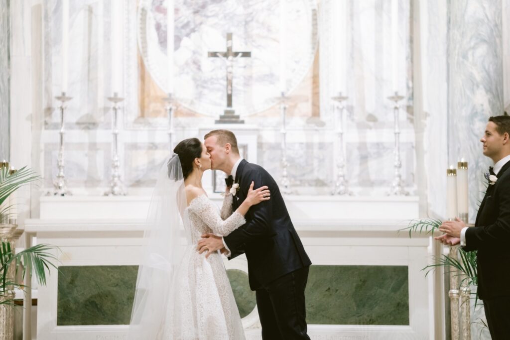 Newlyweds first kiss at a church wedding ceremony in Philadelphia