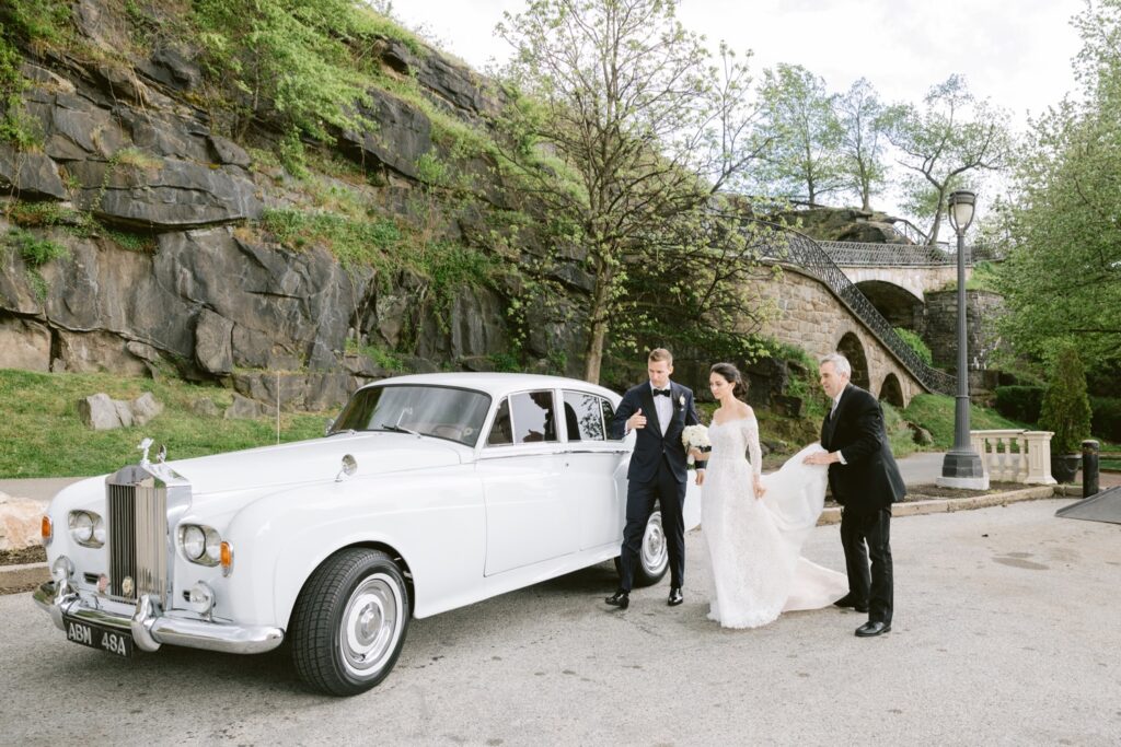 Newlyweds with a vintage Rolls Royce on their elegant spring wedding day