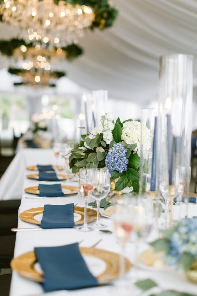 Low table centerpieces with blue hydrangeas and gold details