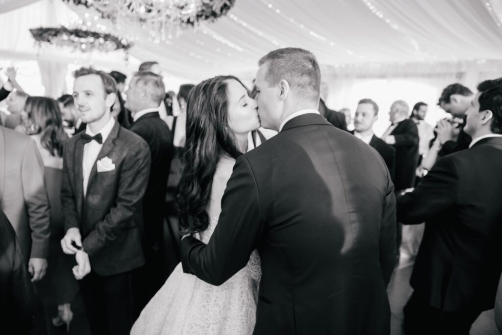 Bride and groom share a kiss on the dance-floor of their Cescaphe wedding reception