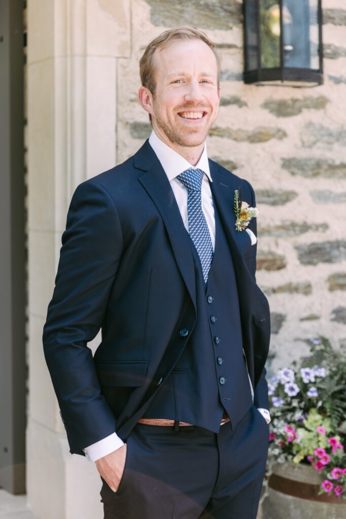 Groom smiling after getting ready for a spring wedding day in Philadelphia
