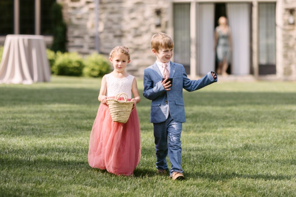 Flower girl and ring bearer walking down the aisle during an enchanted forest wedding ceremony in Philadelphia