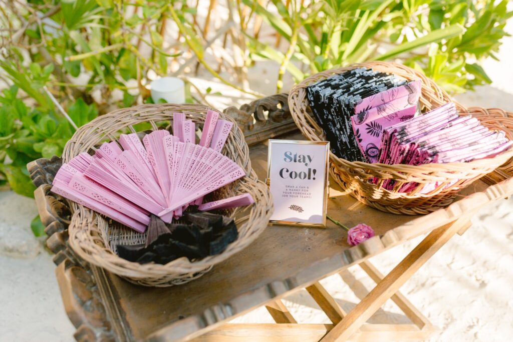 Fans for guests to use at a beach destination wedding ceremony