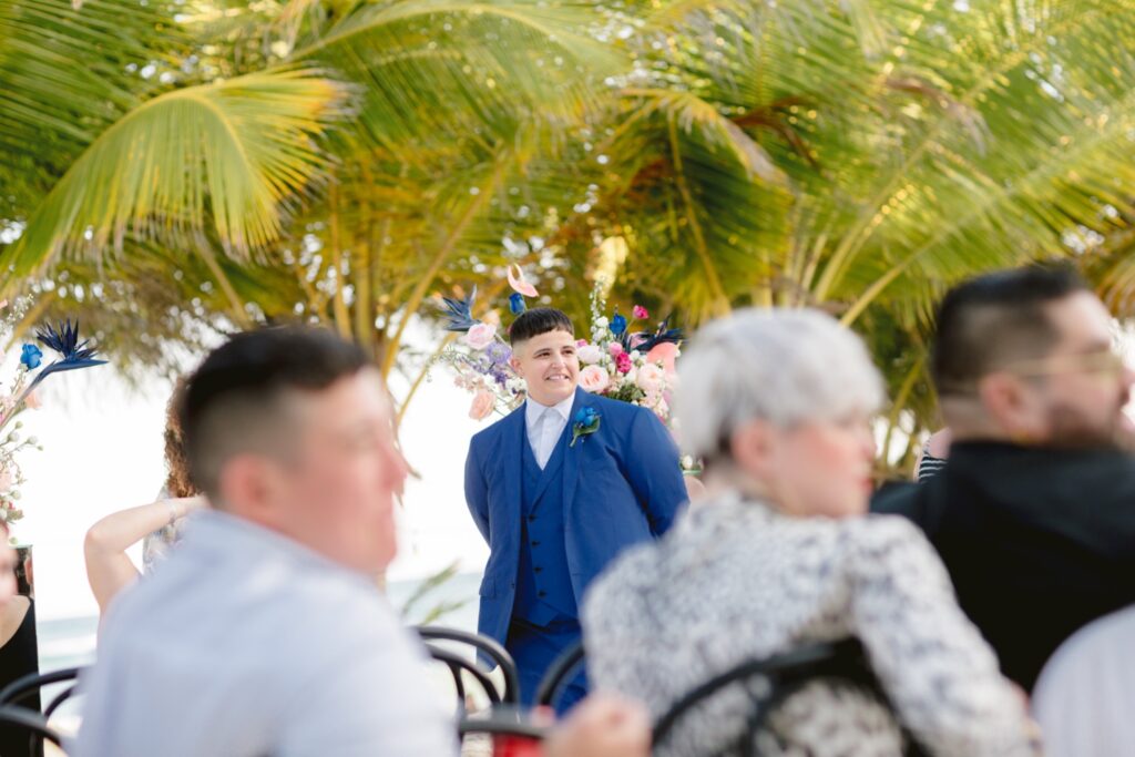 LGBTQ bride sees her partner for the first time during a tropical wedding ceremony