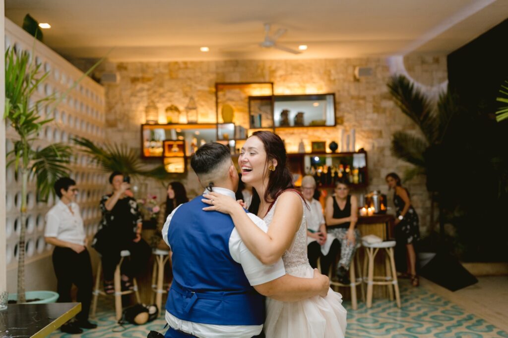 Bride laughing during a romantic first dance at a tropical Mexican wedding