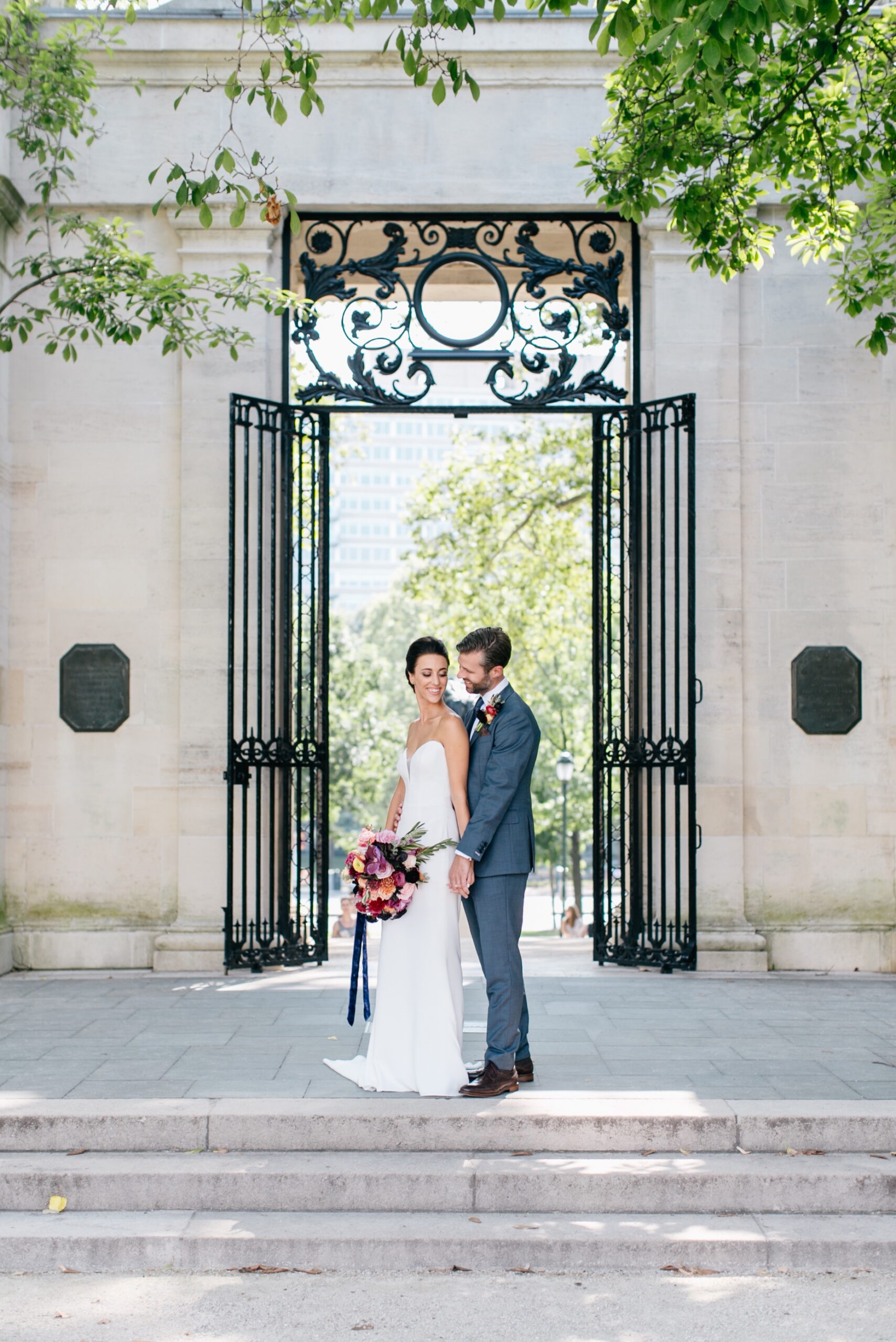 Bride and groom holding hands inside the Rodin Museum by Emily Wren Photography
