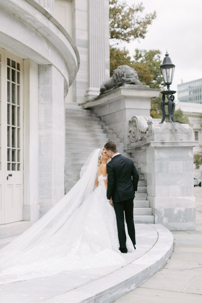 Bride and groom kissing at the Merchant Exchange Building in Philadelphia