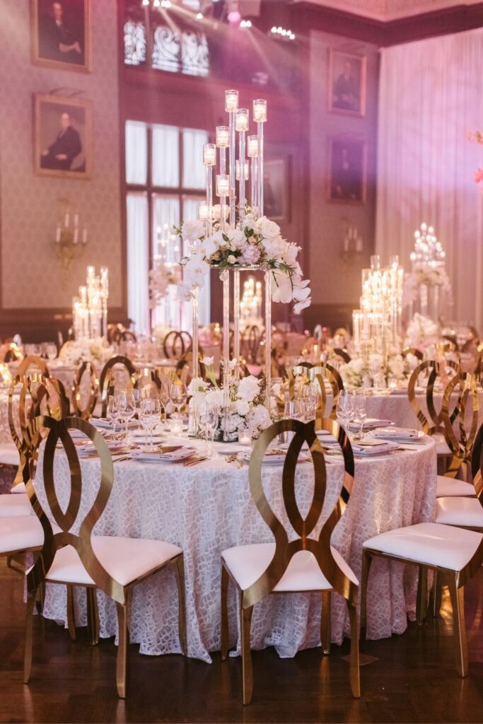 Opulent tablescape with tall candle centerpieces at a pink wedding reception