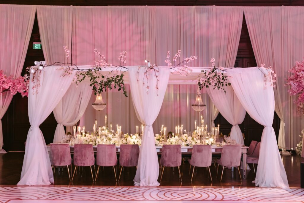Luxe pink themed head table at an upscale wedding reception in Philadelphia