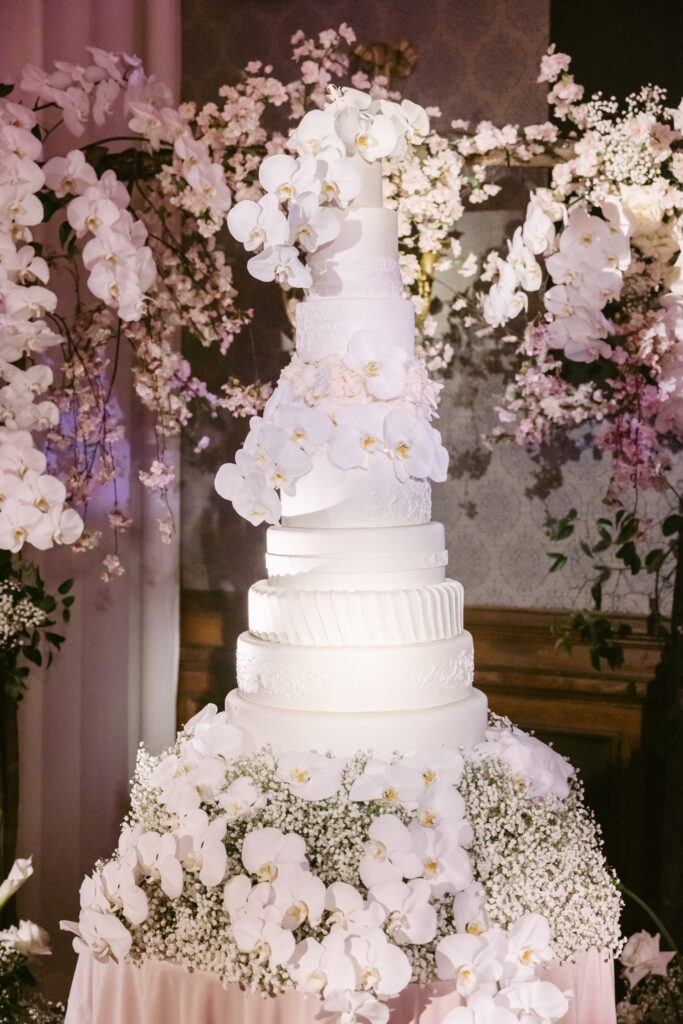 Dramatic tiered wedding cake with white orchids at an upscale Union League reception