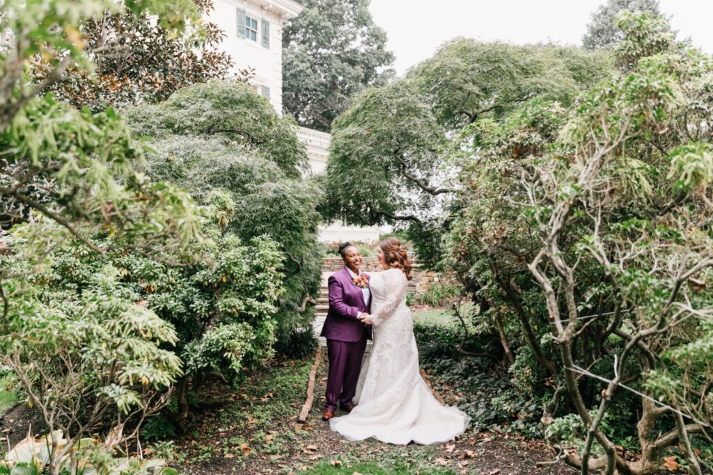 Brides surrounded by lush greenery on their wedding day at Glen Foerd on the Delaware