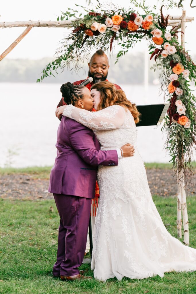 Lesbian couple's first kiss at their fall outdoor wedding ceremony in Pennsylvania