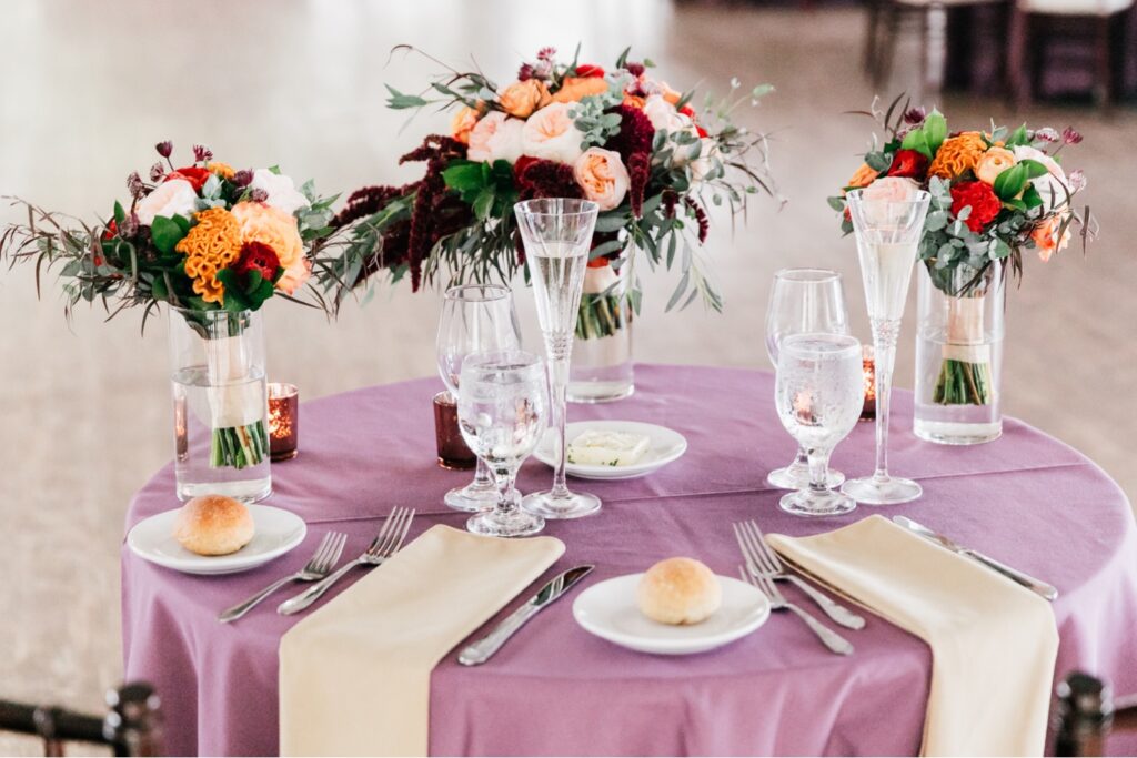 Sweetheart table decor at a purple wedding reception by Emily Wren Photography