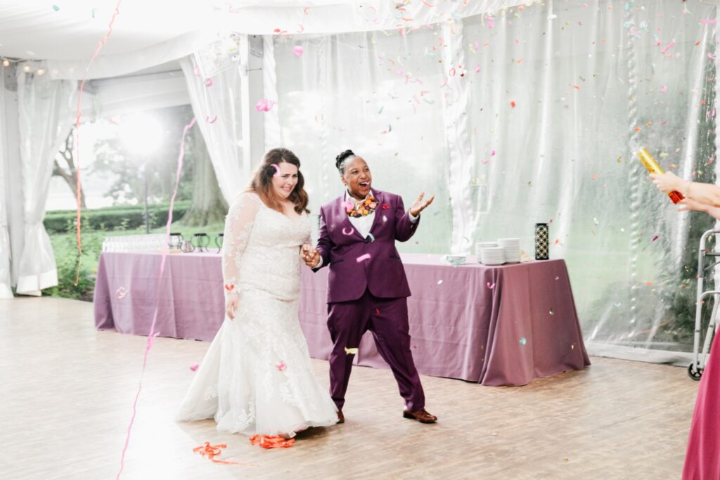 Confetti filled reception entrance for an interracial couple by Emily Wren Photography