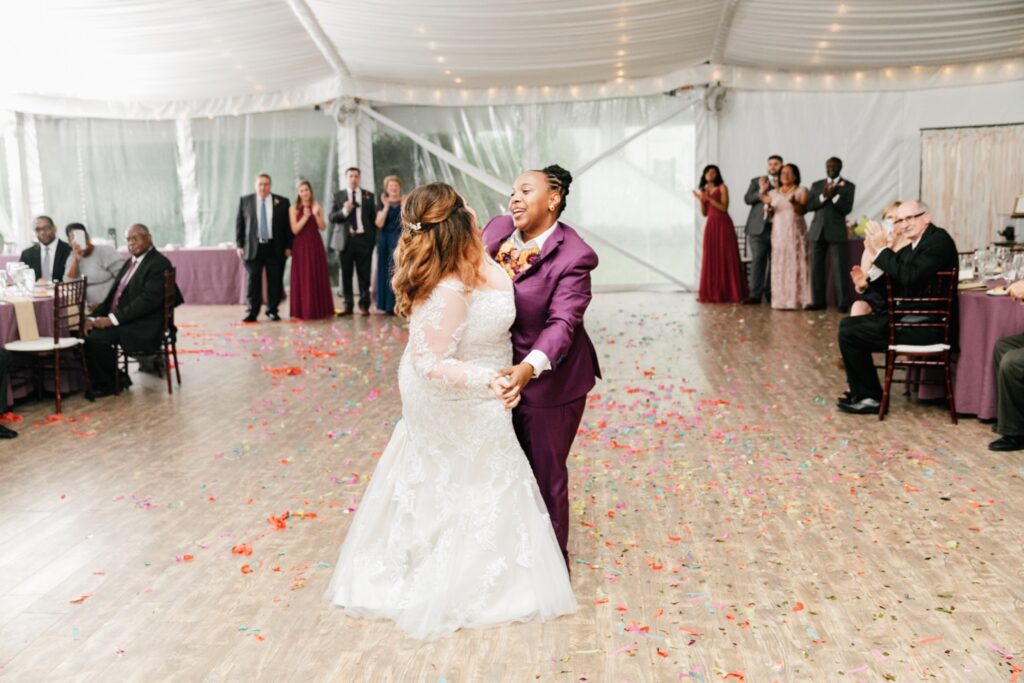 Lesbian couple's first dance at their playful wedding reception