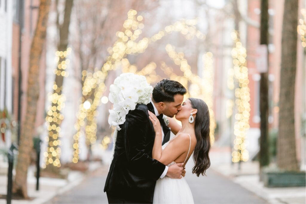 Bride and groom kissing on their NYE wedding day by Emily Wren Photography