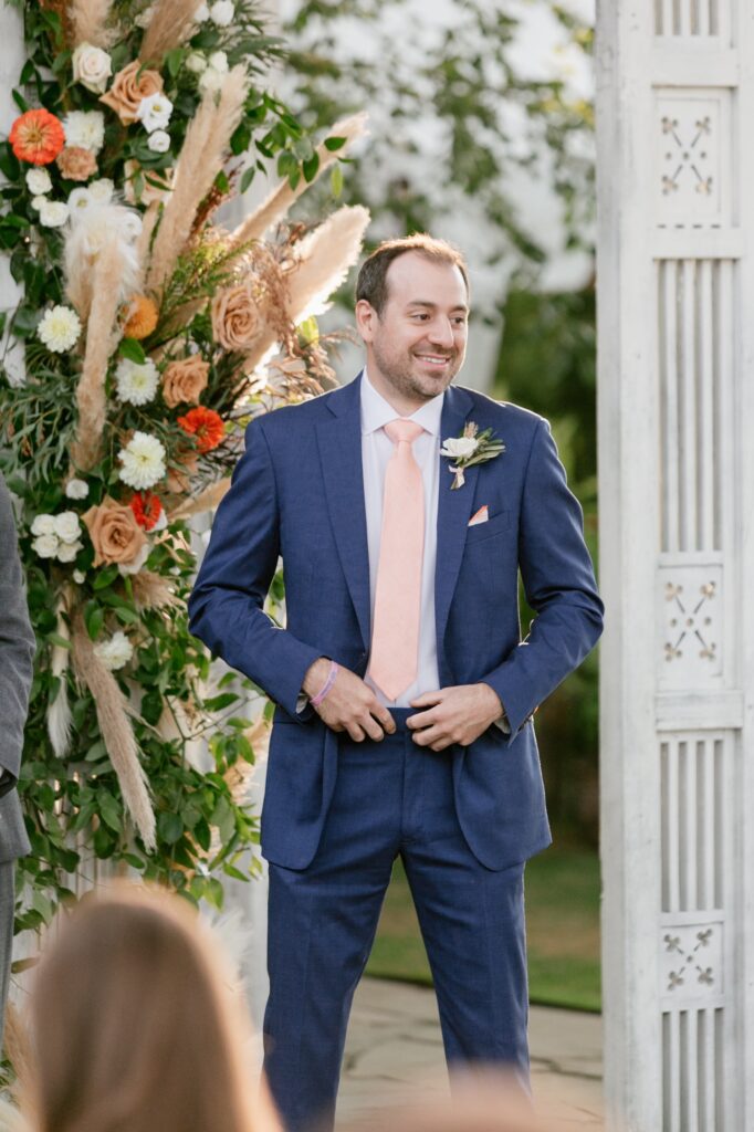 Groom sees the bride for the first time during an intimate summer wedding ceremony