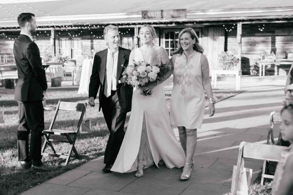 Bride escorted down the aisle by her parents during a covid micro wedding at Terrain in Glen Mills