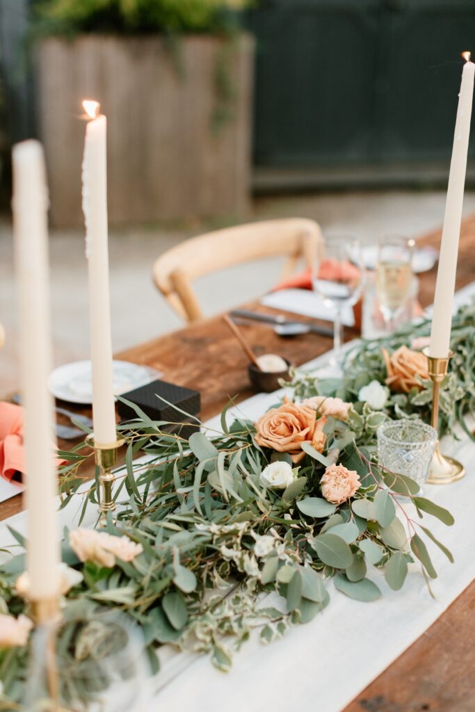 Candles and table runner at an al fresco wedding celebration in Glen Mills