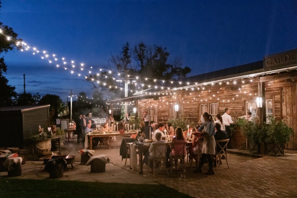 Small garden wedding reception at night by Emily Wren Photography