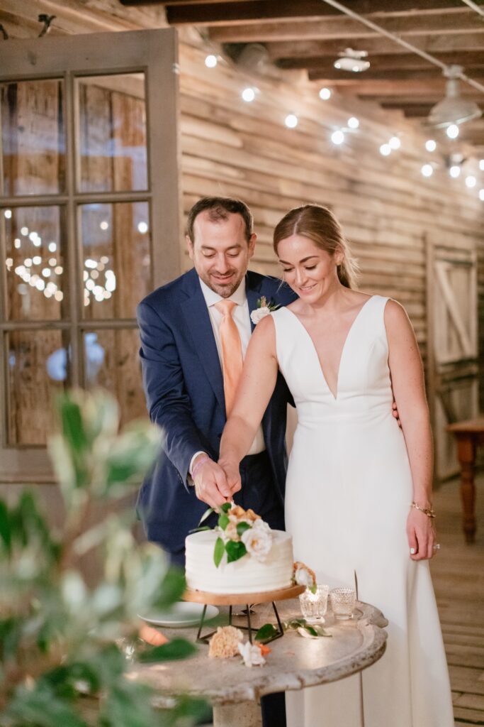 Bride and groom cut the cake at an intimate garden reception on a summer wedding day