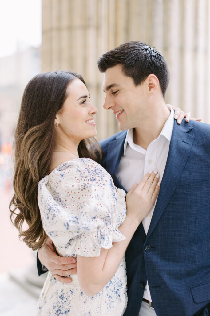 Couple smiling during cherry blossom filled engagement session in Philadelphia