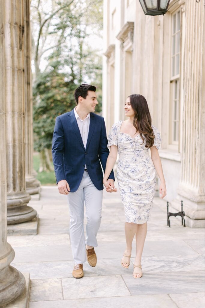 Couple walking and holding hands at the First National Bank in Philadelphia for a spring engagement
