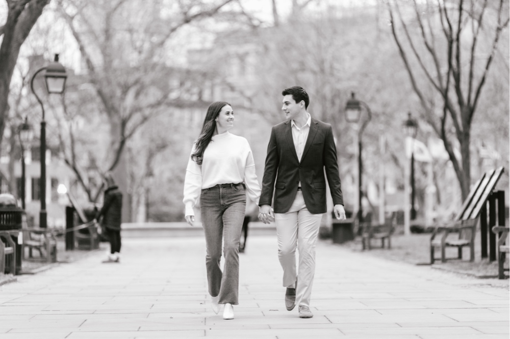 Couple walking in Philadelphia's Washington Square Park during a spring engagement session with Emily Wren Photography
