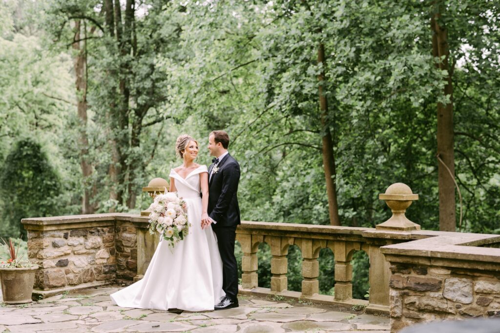 Bride and groom on a stone patio at an estate wedding