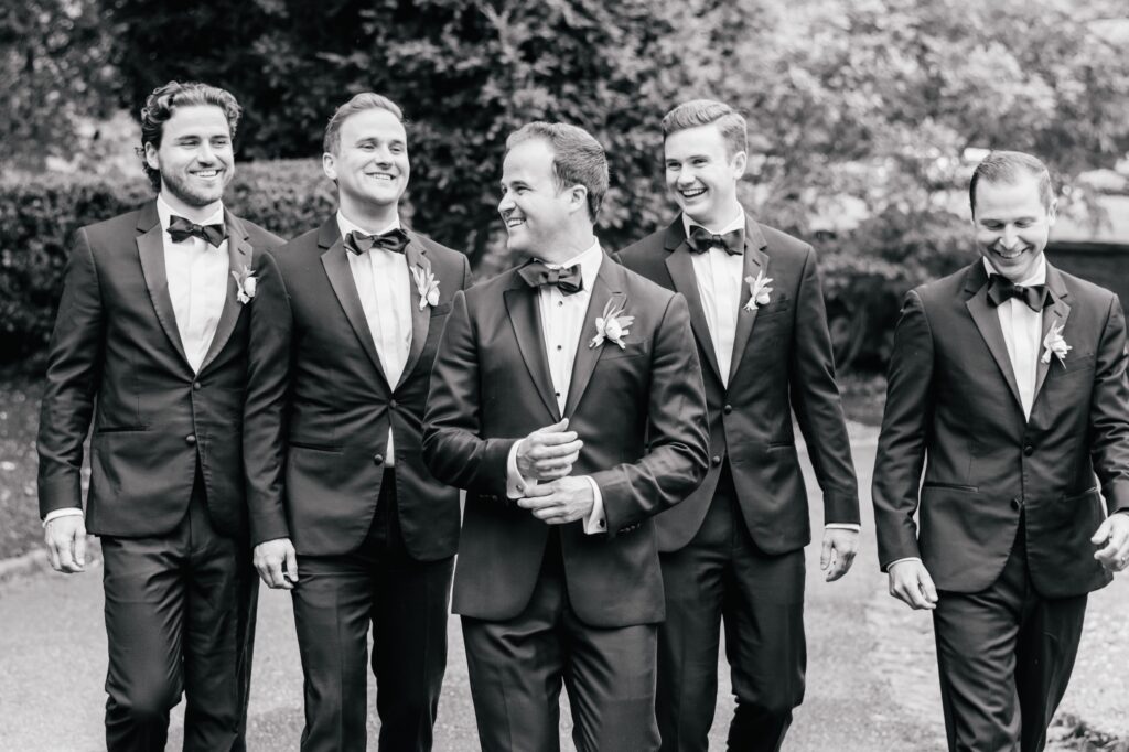 Groom and groomsmen talking and laughing
