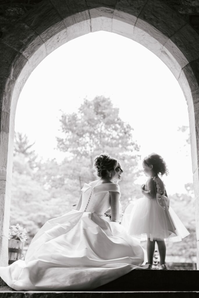 Bride with the flower girl at a timeless wedding by Emily Wren Photography