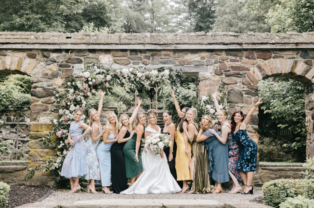 Bride celebrating with her friends at a garden cocktail hour at a spring wedding