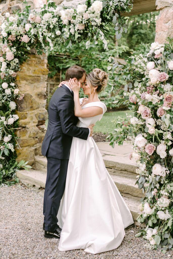 Bride and groom surrounded by lush flowers at a garden wedding in Philadelphia