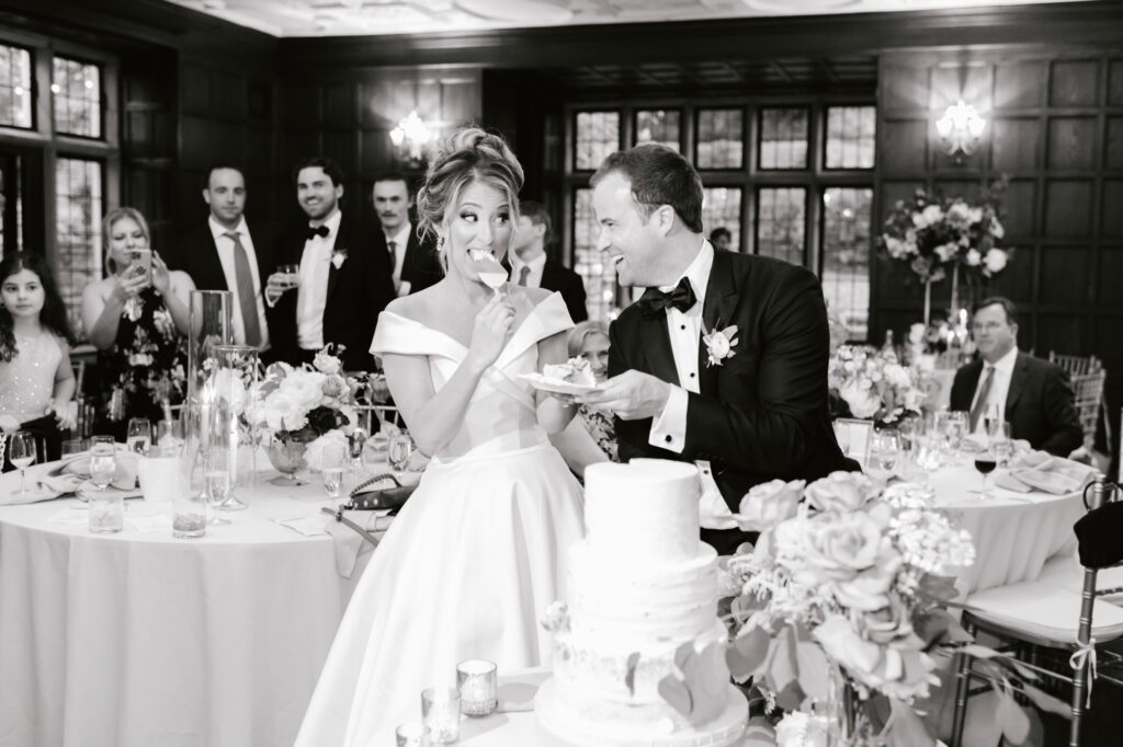 Bride eating her wedding cake at a spring wedding reception by Emily Wren Photography