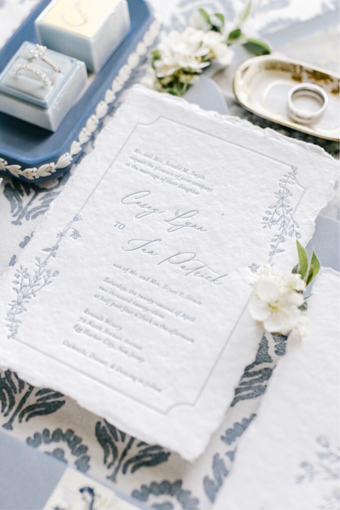 Blue and white letter-pressed wedding invitation suite with hand torn edges