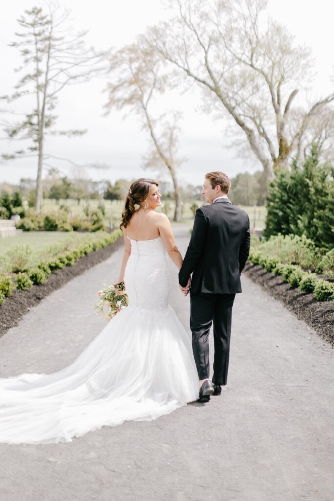 Bride and groom holding hands and walking at a New Jersey winery wedding