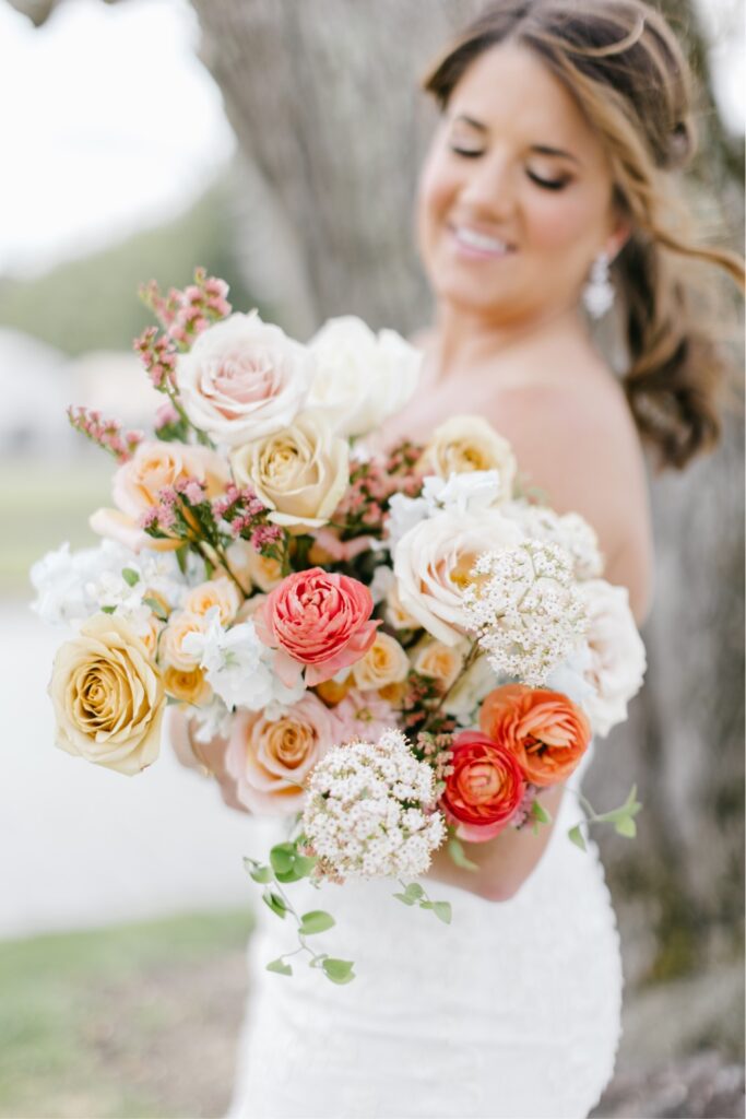 Colorful spring wedding bouquet with pink and orange flowers