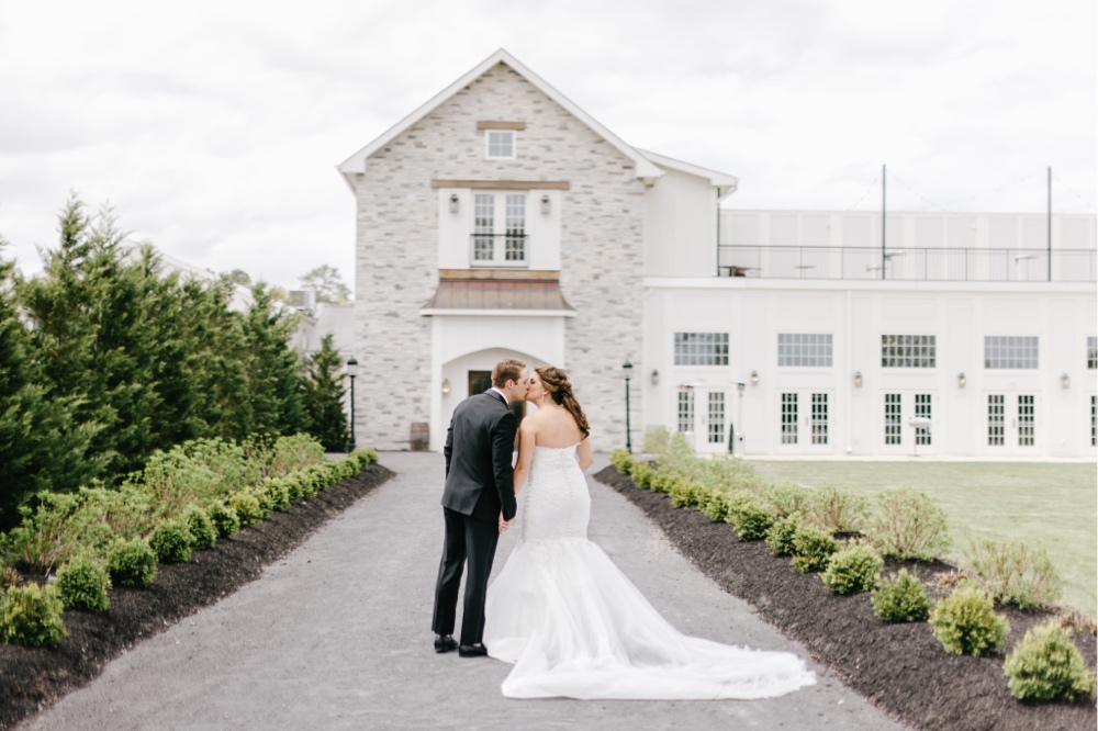 Bride and groom kissing at a winery in Cape May, New Jersey by Emily Wren Photography