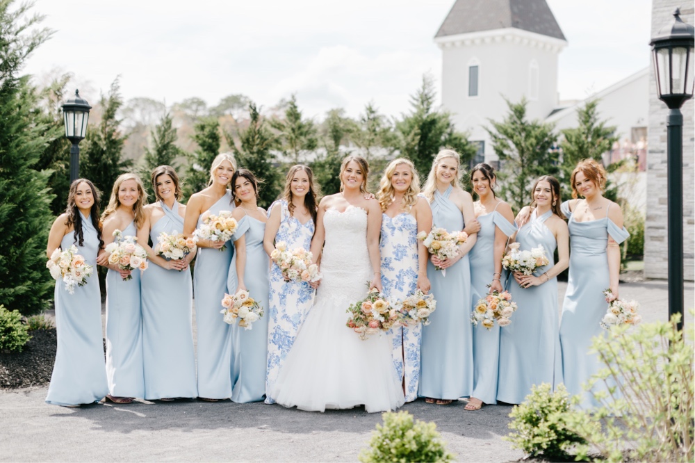 Bridesmaids in pastel blue dresses for an elegant spring winery wedding by Emily Wren Photography