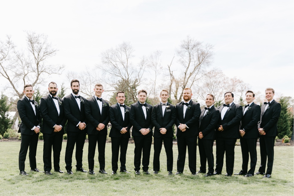 Groomsmen smiling before a enchanting spring wedding reception at Renault Winery