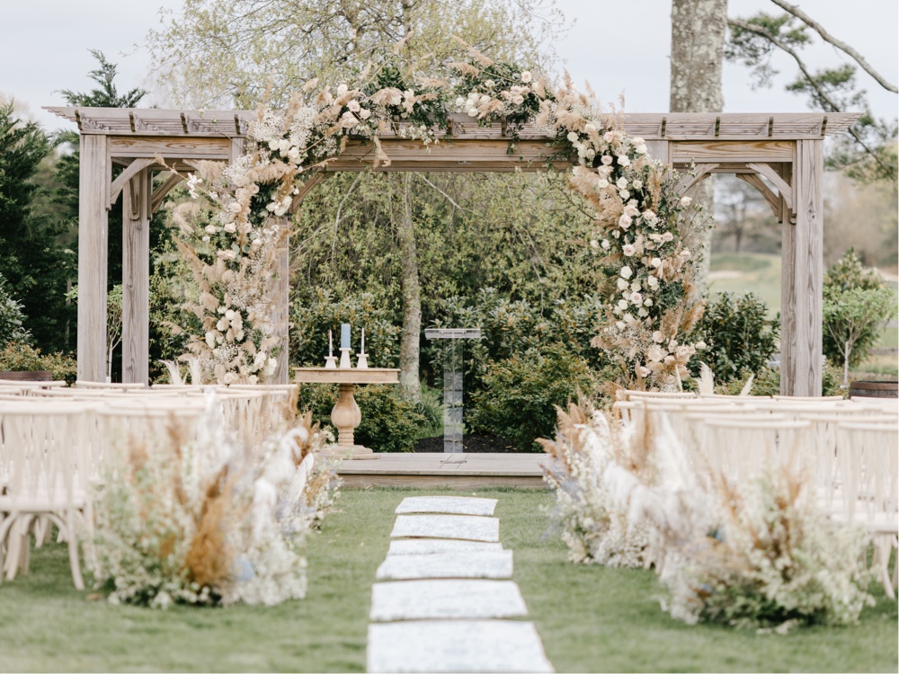 Enchanting spring wedding ceremony with rustic details and a luxury ceremony arch