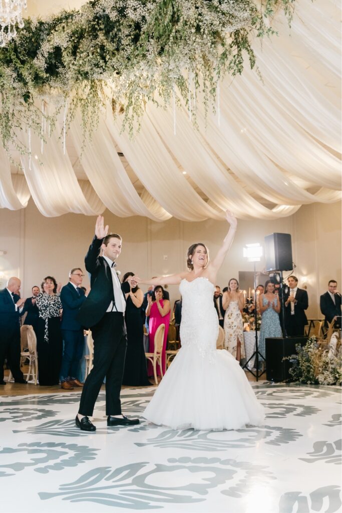 Bride and groom enter the reception at a luxury ballroom wedding reception